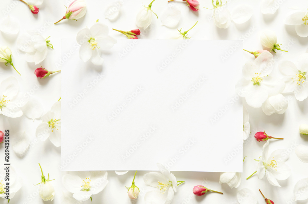 Fototapeta premium Creative layout of summer fresh flowers with space for text on white paper. Mockup. View from above. - Image
