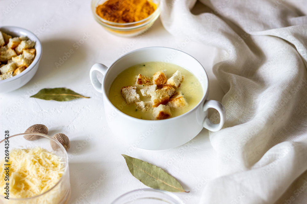 Cheese cream soup on a white background. White bread croutons. Ingredients. Cheese cream soup on a white background. White bread croutons. Ingredients.