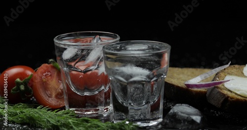 Alcohol drink vodka in shot glasses. Surface with snacks
