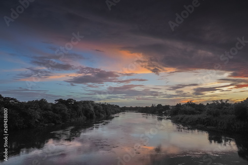 sunset at Mae Klong river  view of soft sun light above the river with cloudy sky background  Ban Pong District  Ratchaburi  Thailand.
