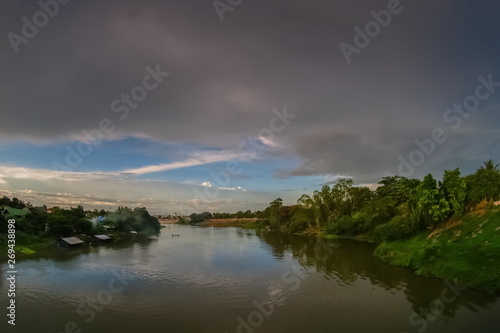 river view evening of Mae Klong river with soft rain and cloudy sky background, Ban Pong District, Ratchaburi, Thailand.