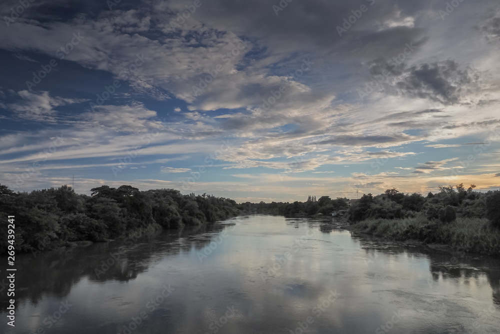 Panorama river view evening of Mae Klong river with soft rain and cloudy sky background, Ban Pong District, Ratchaburi, Thailand.