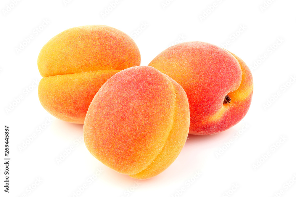 Three apricots isolated close-up. Three apricots isolated close-up.