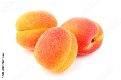 Three apricots isolated close-up.