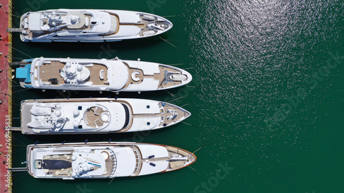 Photography Aerial drone top view photo of luxury yachts docked in mediterranean destination