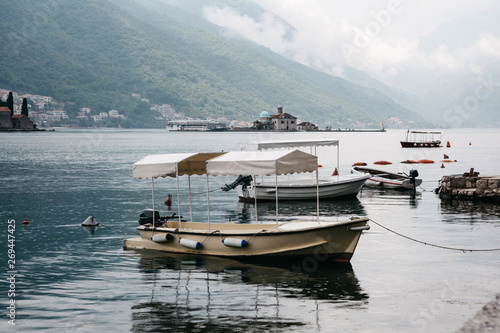 Beautiful view of the Bay of Kotor in Montenegro near the city of Perast. In the background there is an island with a church in the sea and in the foreground are many boats.