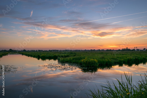 Scenic sunset over calm water in the dutch countryside near Gouda, Holland