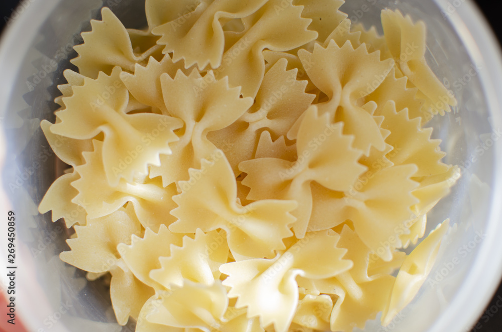 Italian uncooked pasta. Raw farfalle. Healthy food. Italian dishes. Italian uncooked pasta. Raw farfalle. Healthy food. Italian dishes.