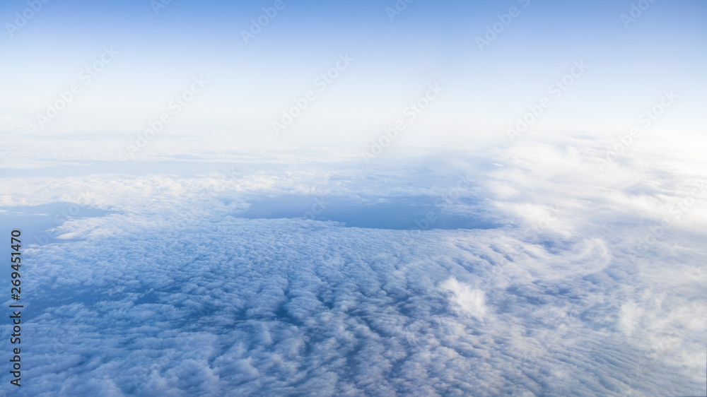 The beautiful cloudscape with clear blue sky. A view from airplane window. The beautiful cloudscape with clear blue sky. A view from airplane window.