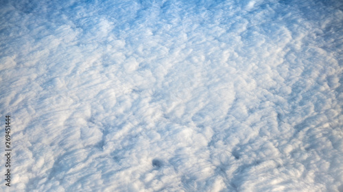 Wonderful view of cloudscape with clear blue sky from above.