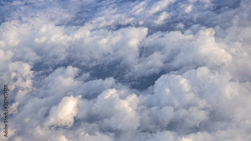 The beautiful cloudscape with clear blue sky. A view from airplane window.