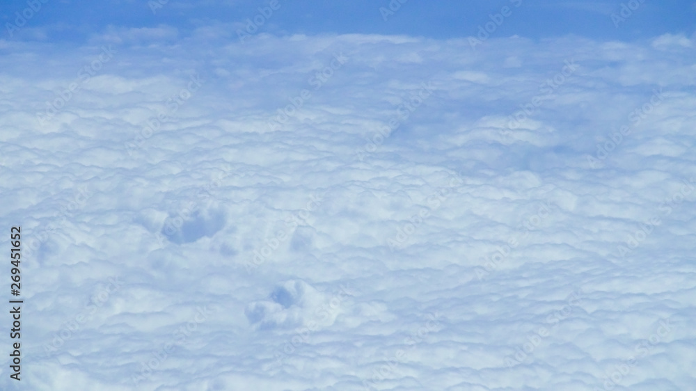 The beautiful cloudscape with clear blue sky. A view from airplane window. The beautiful cloudscape with clear blue sky. A view from airplane window.