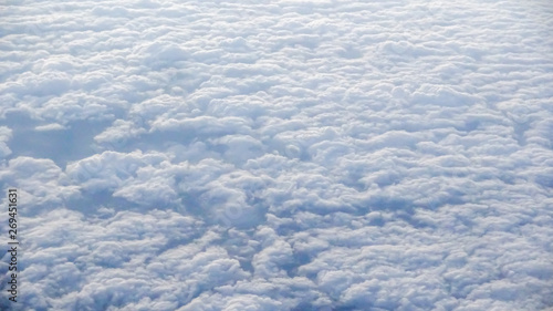 The beautiful cloudscape with clear blue sky. A view from airplane window.