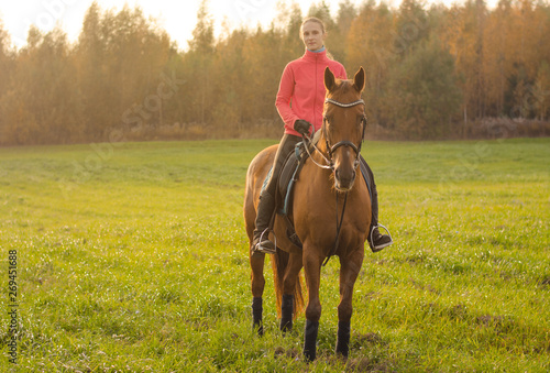 portrait of young woman and mare horse in autumn field © vprotastchik