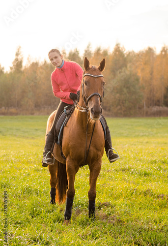 portrait of young woman and mare horse in autumn field © vprotastchik