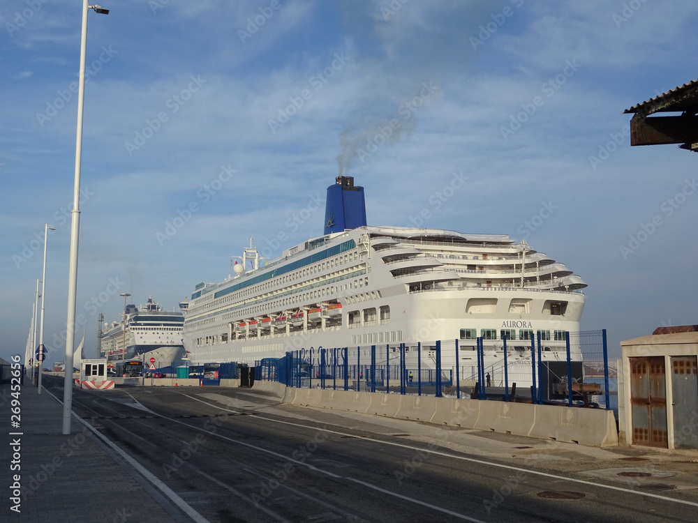 cruise ship at the dock unloading passengers with bus shuttles