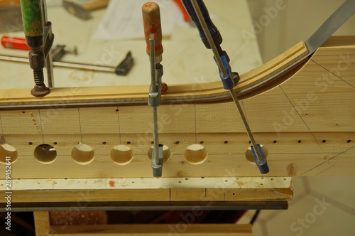 Bow-Maker in his own workshop, How to Make a Bow, close up of making recurved bow in workshop, male bow-maker photo