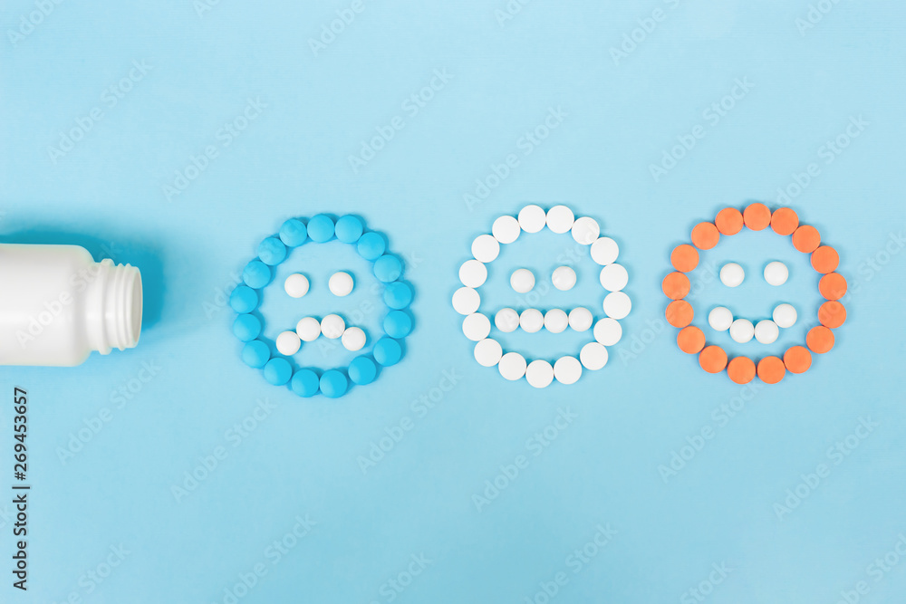 © Olga - Multicolored pills and funny faces and a plastic bottle on a blue background. The concept of antidepressants and healing. Copy space. © Olga - Multicolored pills and funny faces and a plastic bottle on a blue background. The concept of antidepressants and healing. Copy space.