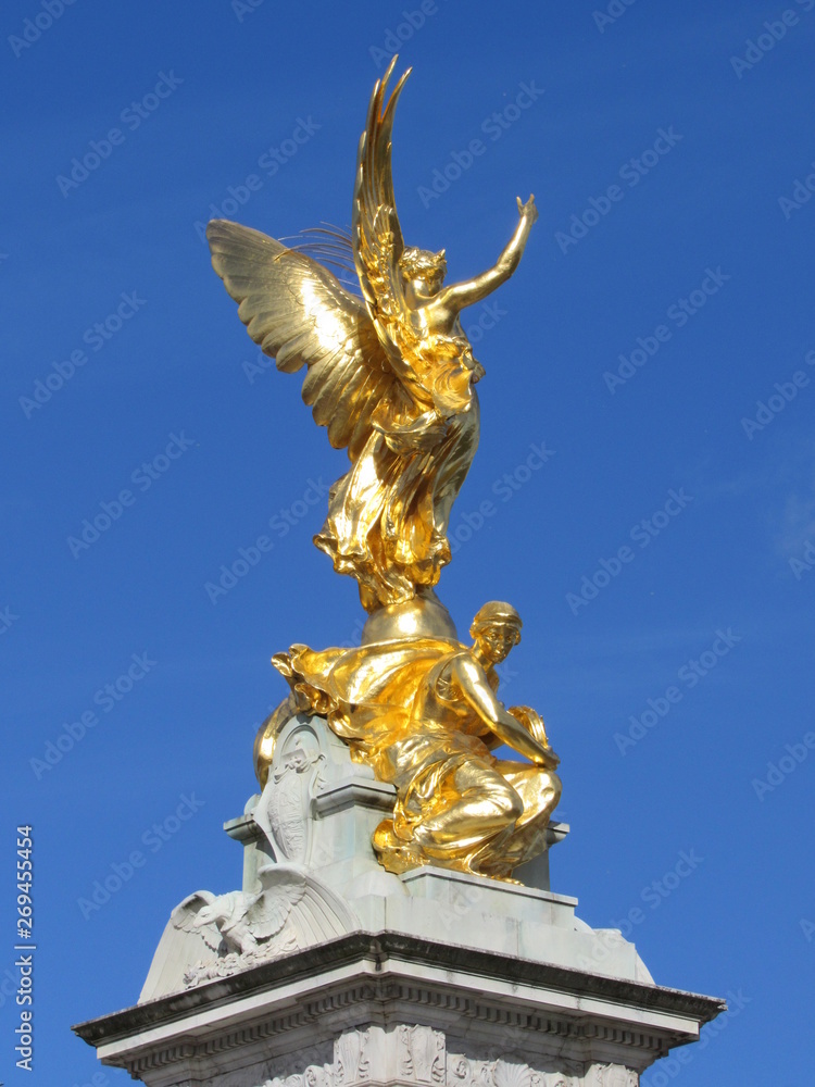 View of the Queen Victoria Memorial located in front of Buckingham Palace with blue sky in the background