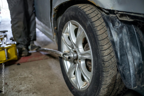 Unscrew the hub in the wheel of the car. Car repair in car service © yaroslav1986