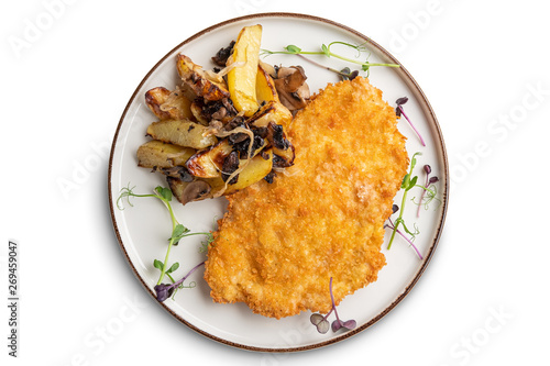 Tasty schnitzel in breading with fried potato, onion and mushrooms