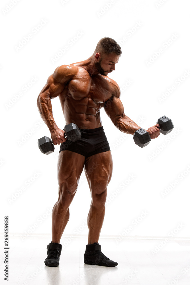 Muscular Men Lifting Weights. Bodybuilder Performing Dumbbel Biceps Curls Muscular Men Lifting Weights. Bodybuilder Performing Dumbbel Biceps Curls
