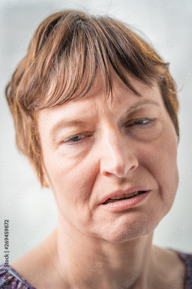 Naklejka premium Paris, France - 05 19 2019: Studio photo session with my girlfriend. Woman with bad expressive face