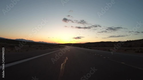 Nevada desert Highway 159 sunrise rear view drivng time lapse at Red Rock Canyon National Conservation Area near Las Vegas.   photo