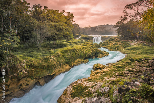 Amazing sunset over the turquoise waterfalls at Las Nubes in Chiapas, Mexico photo