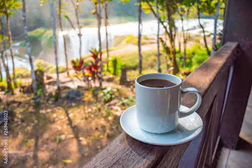 Coffee with a view, at background the turquoise waterfalls at Las Nubes in Chiapas, Mexico photo