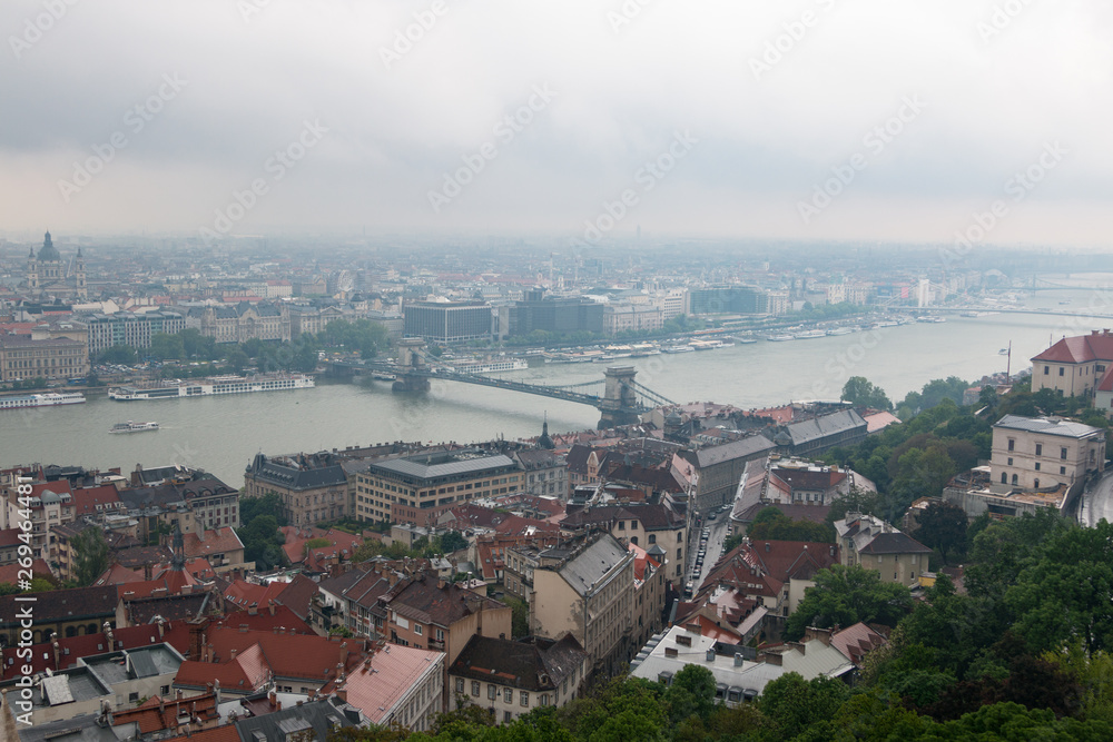 Budapest, Hungary. View of the city in cloudy weather from the tower of the Cathedral of St. Matthias. Danube River. Spring. Tourism and travel. Skyview. Top view.