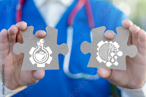 Scientific medical worker holds puzzle pieces with flask gear and digital nano microchip icons. Health Lab Innovative Nanotechnologies concept. Medical Computing Research. photo