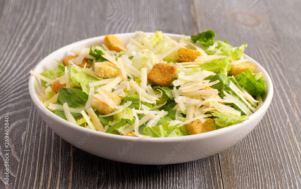 Fresh Caesar Salad on a Wooden Table Fresh Caesar Salad on a Wooden Table
