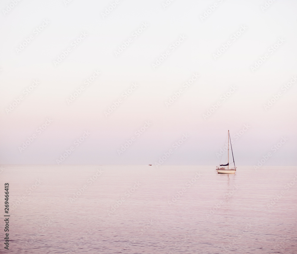 view of sailboats at sea during sunrise