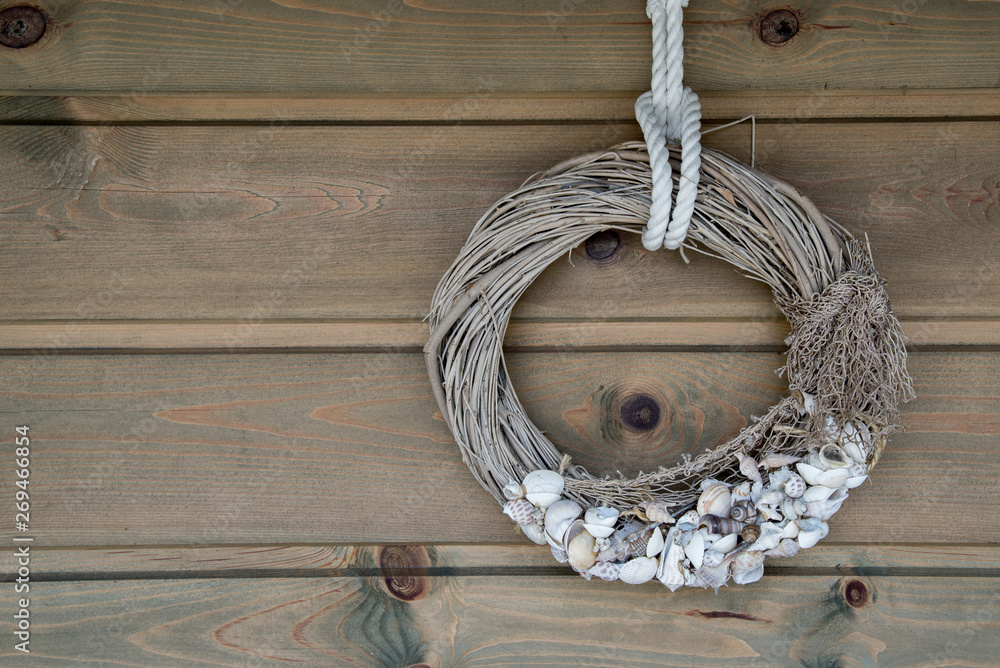 Wooden wall decoration with Sea thematic frame, decorated with seashells. Marine themes in hand work for interior decoration.