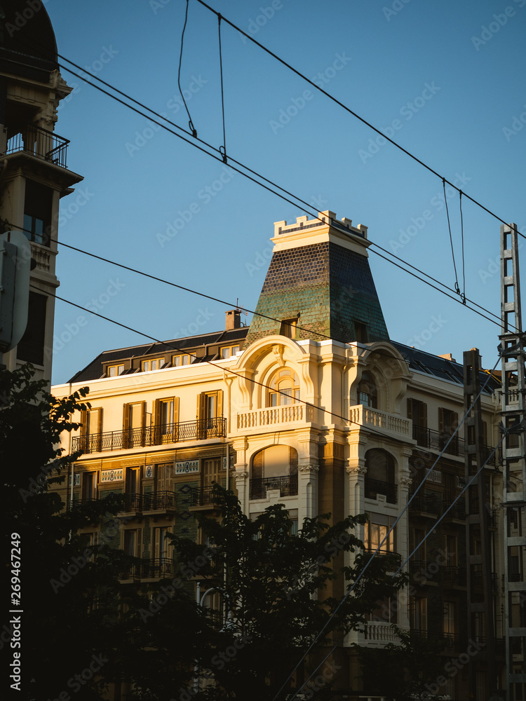 Golden light hitting the top of an old building. European architecture