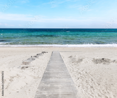 Wooden path on the sandy beach