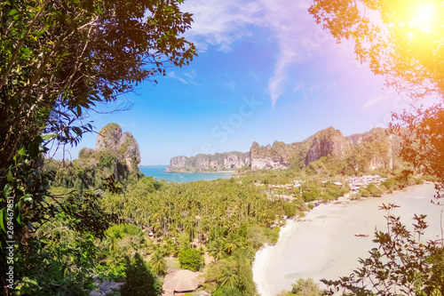 Panorama of the two sides of Railay peninsula, Krabi, Thailand, from a high view point at sunny day. A bit cloudy blue sky and mountains.