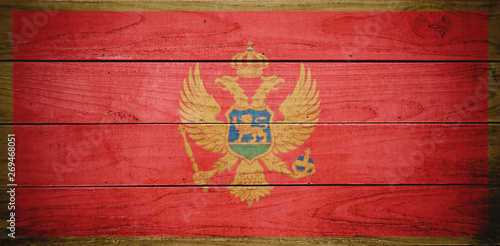 Flag of Montenegro, wooden background, dirty.