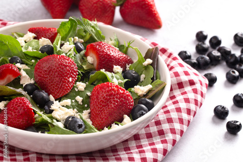 Bright Garden Salad with Fresh Fruit on a Red Gingham Tablecloth