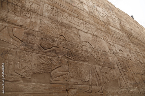 Wall with hieroglyphs of Karnak Temple in Luxor, Egypt. The temple complex at Karnak includes many ancient chapels, temples, monuments and columns of the ancient Egyptian civilization