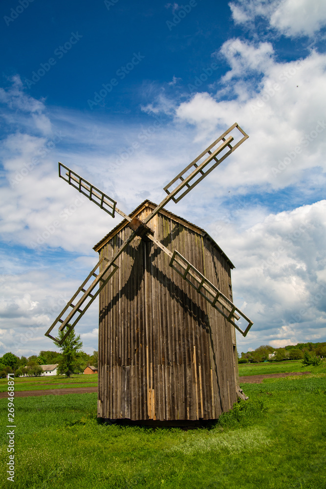 Old wooden mill on the background of beautiful nature.