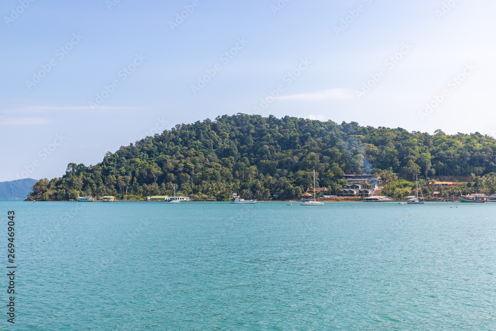 Tropical sea Bang Bao bay with boats, piers and tourist resorts on Koh Chang island, Thailand