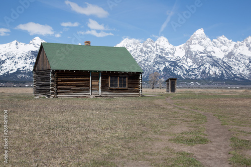 Mormon Row in Grand Teton National Park featuring an abandoned ranch home and outhouse. Taken in mid-May in the afternoon.