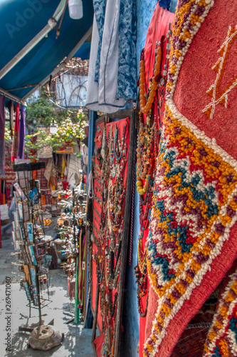 Carpets, crafts and souvenirs exhibited in a street of Chefchaouen (or Chaouen), Morocco. © juanorihuela