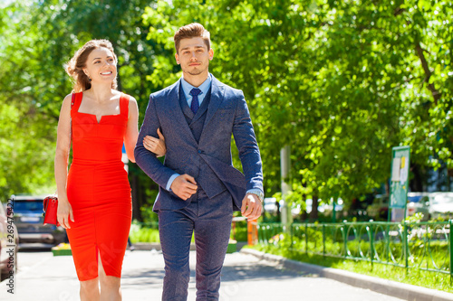 Young couple or european woman and man walking on city street