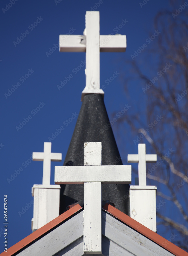 Four white crosses arranged on church roof Four white crosses arranged on church roof
