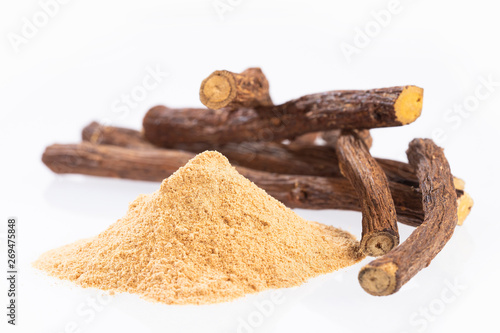 Licorice powder and roots - Glycyrrhiza glabra - White background photo