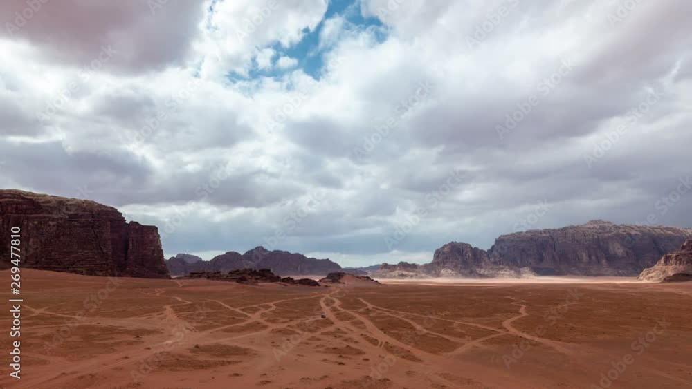 Clouds move fast over stone desert landscape,. time lapse video