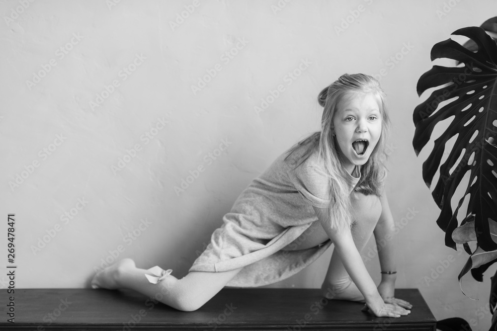 Beautiful little blonde long haired child girl in white tights